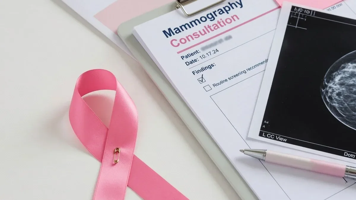 Lazo rosa de concienciación sobre el cáncer de mama junto a documentación clínica